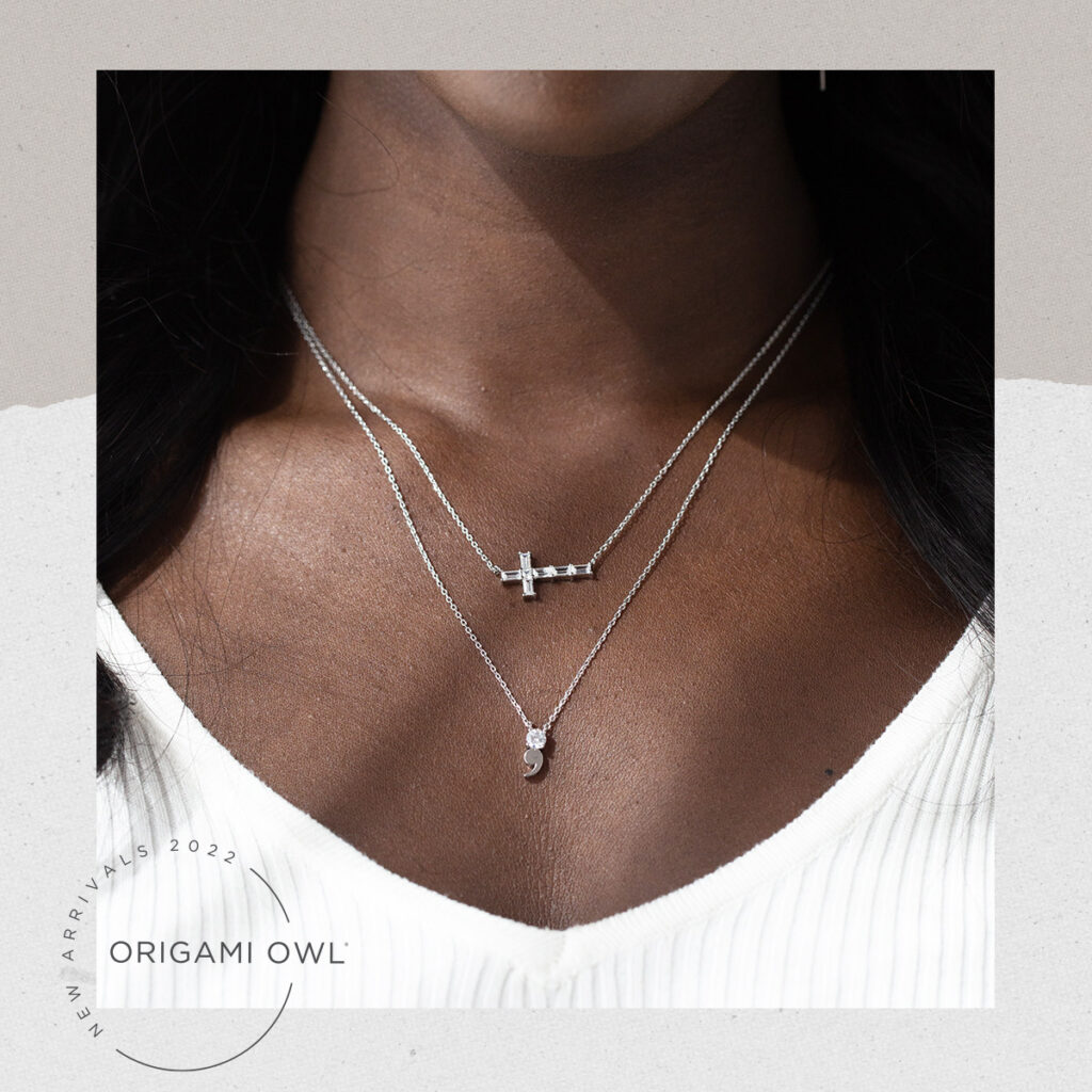 A picture of a lady’s neck wearing 2 empowerment necklaces, one is a cross and one is a semi colon