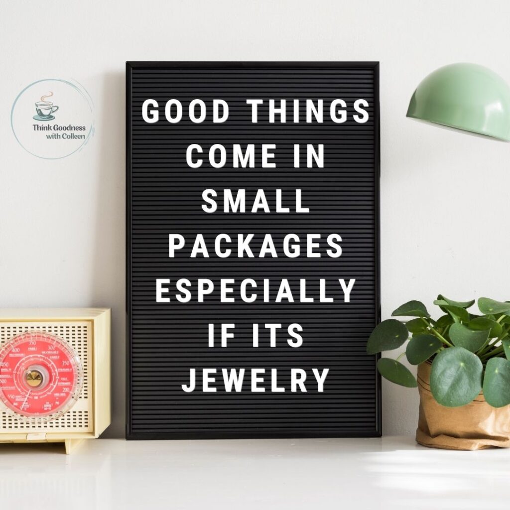 white background with a white and read old radio, plant, lamp  with a black tile board with white letters that says good things come in small packages especially if its jewelry
