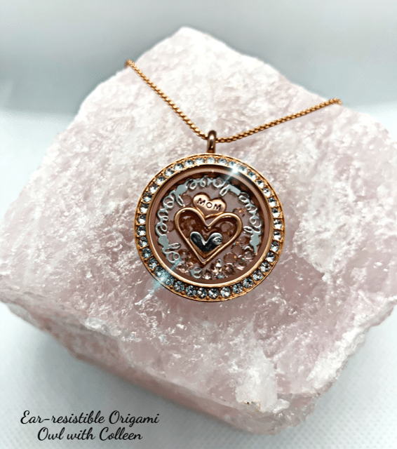 Image of a rose gold round Living Locket with crystals. Inside the locket is a love plate, 2 rose gold heart charms and 1 silver heart charm. This living Locket was the beginning of a Journey to a meaningful purpose and growth