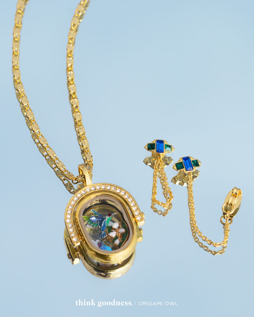 Gold oval spinning locket with chain and charms, Emerald and sapphire gold drop earrings 