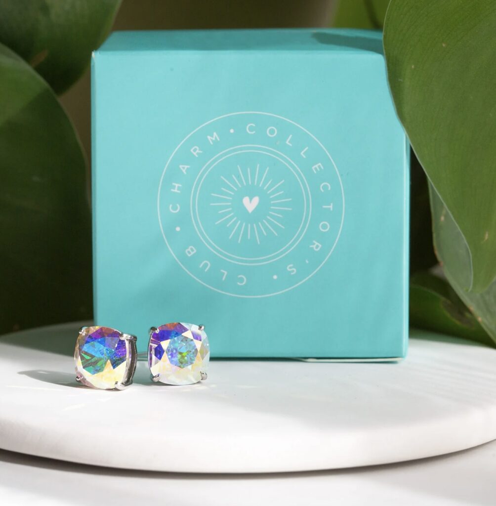An image with a leaf, collector club logo and Aurora Borealis Clara stud earrings 