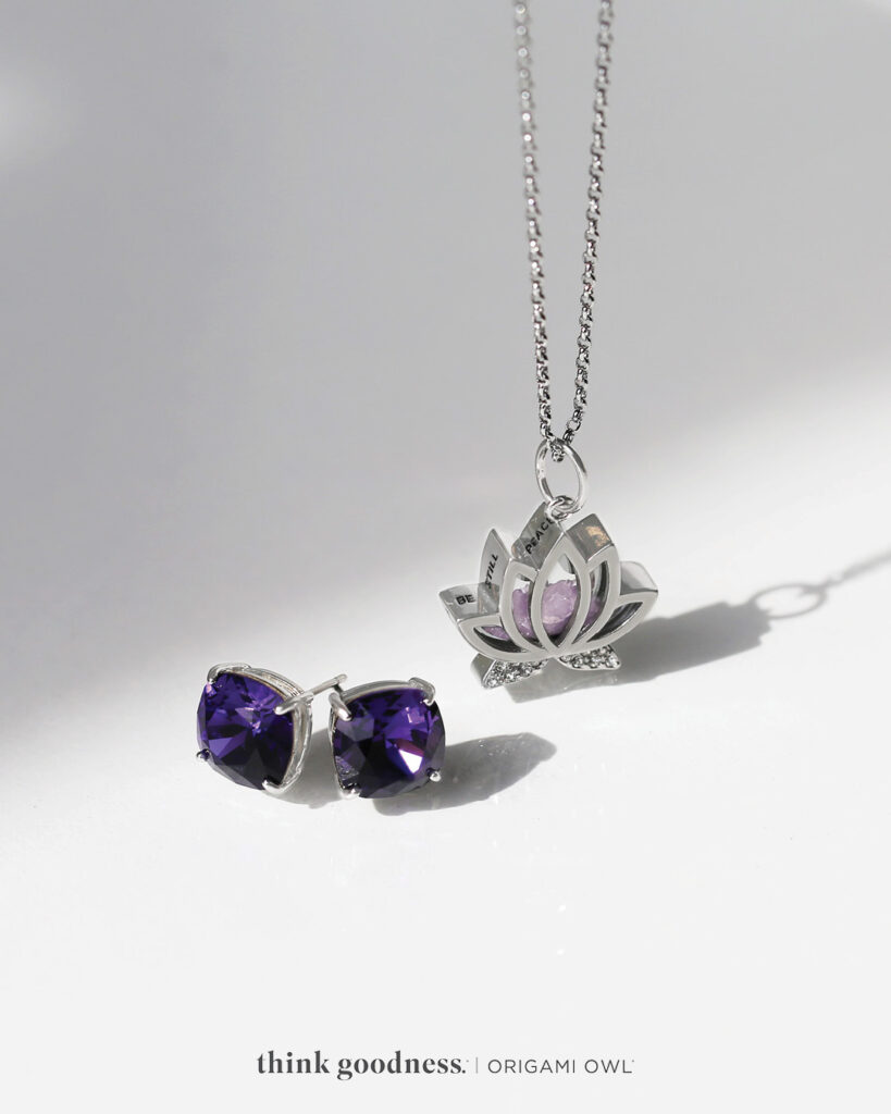 Purple velvet Clara earrings and a lotus capsule locket with crystals on a chain