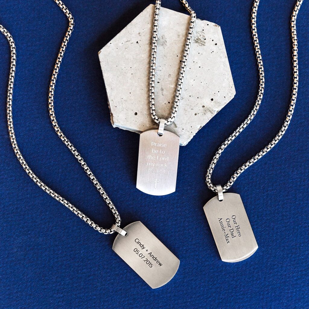 A blue background with 3 inscription dog tags on chains