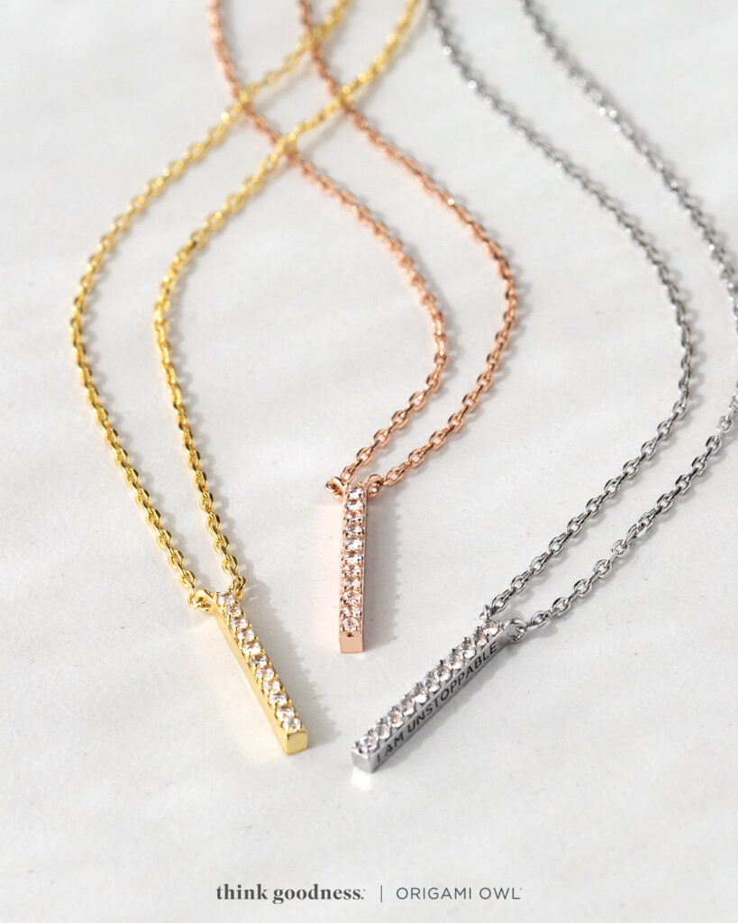 3 CZ pendants on a chain each in a gold, rose gold and silver with unstoppable wrote on the side of each pendant