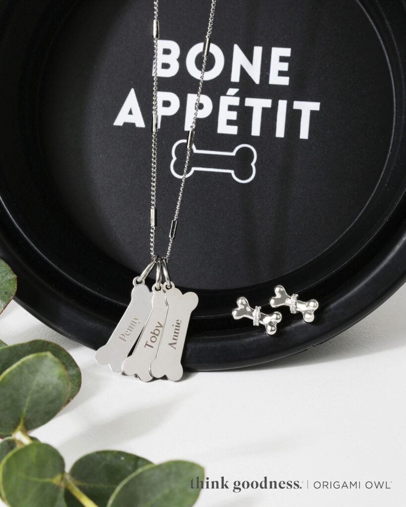 A pet cookie jar that says non appetit with paw bone inscription tags and bone bow earrings 