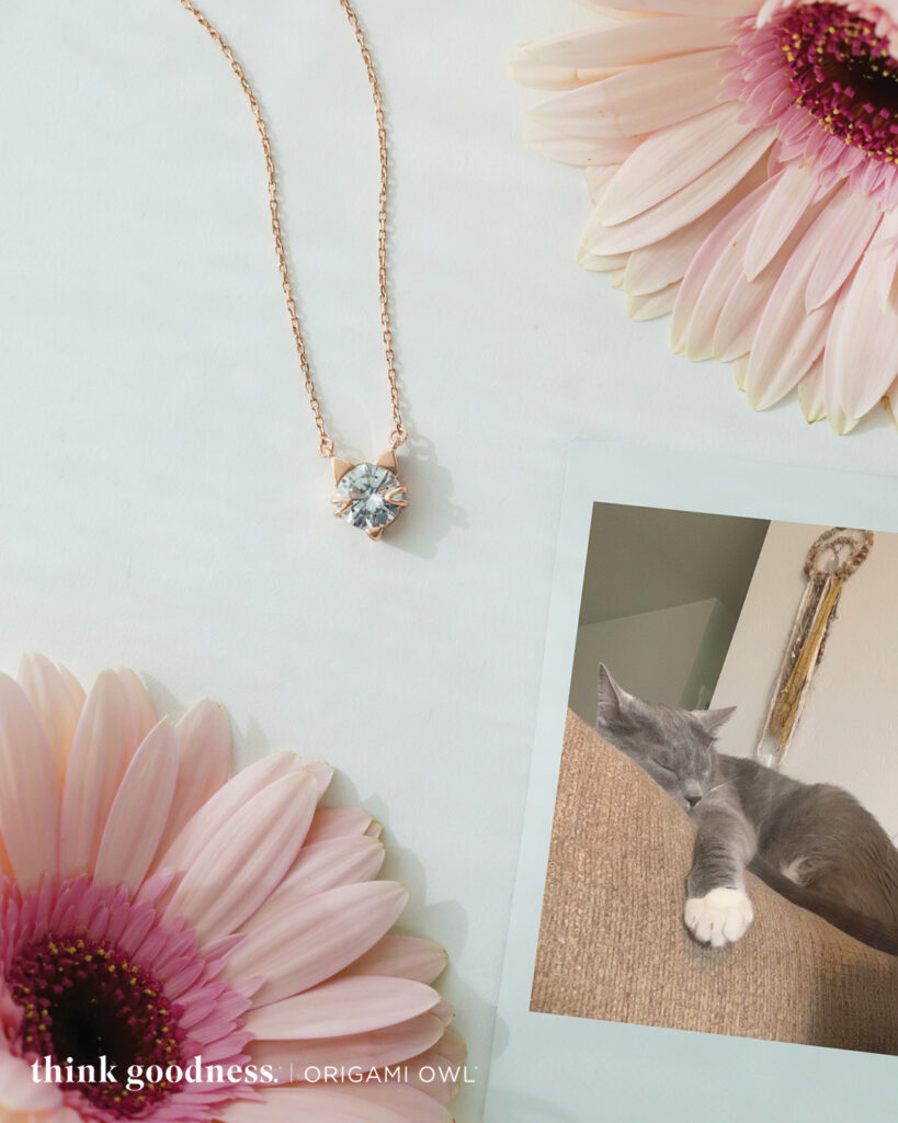 Pink daisies around a rose gold crystal cat necklace
