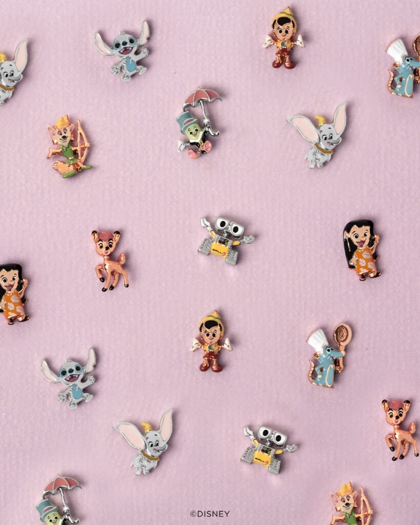 A pink image with Disney 100 years of wonder storytelling collection charms