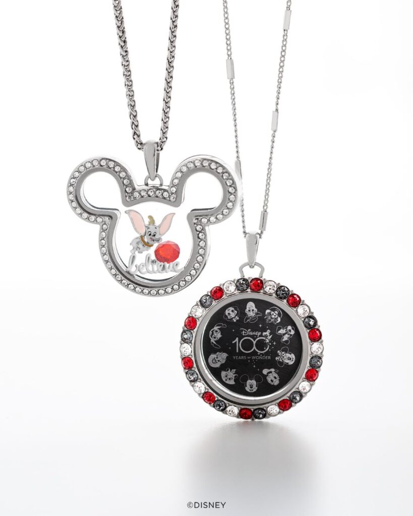 A Mickey Mouse head living locket and a red sparkle round locket that include charms from the Disney 100 years of storytelling collection
