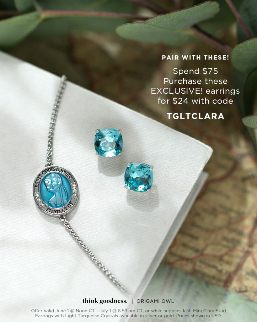 a white book showing one side of the saint christopher medal in silver and the light turquoise mini clara studs