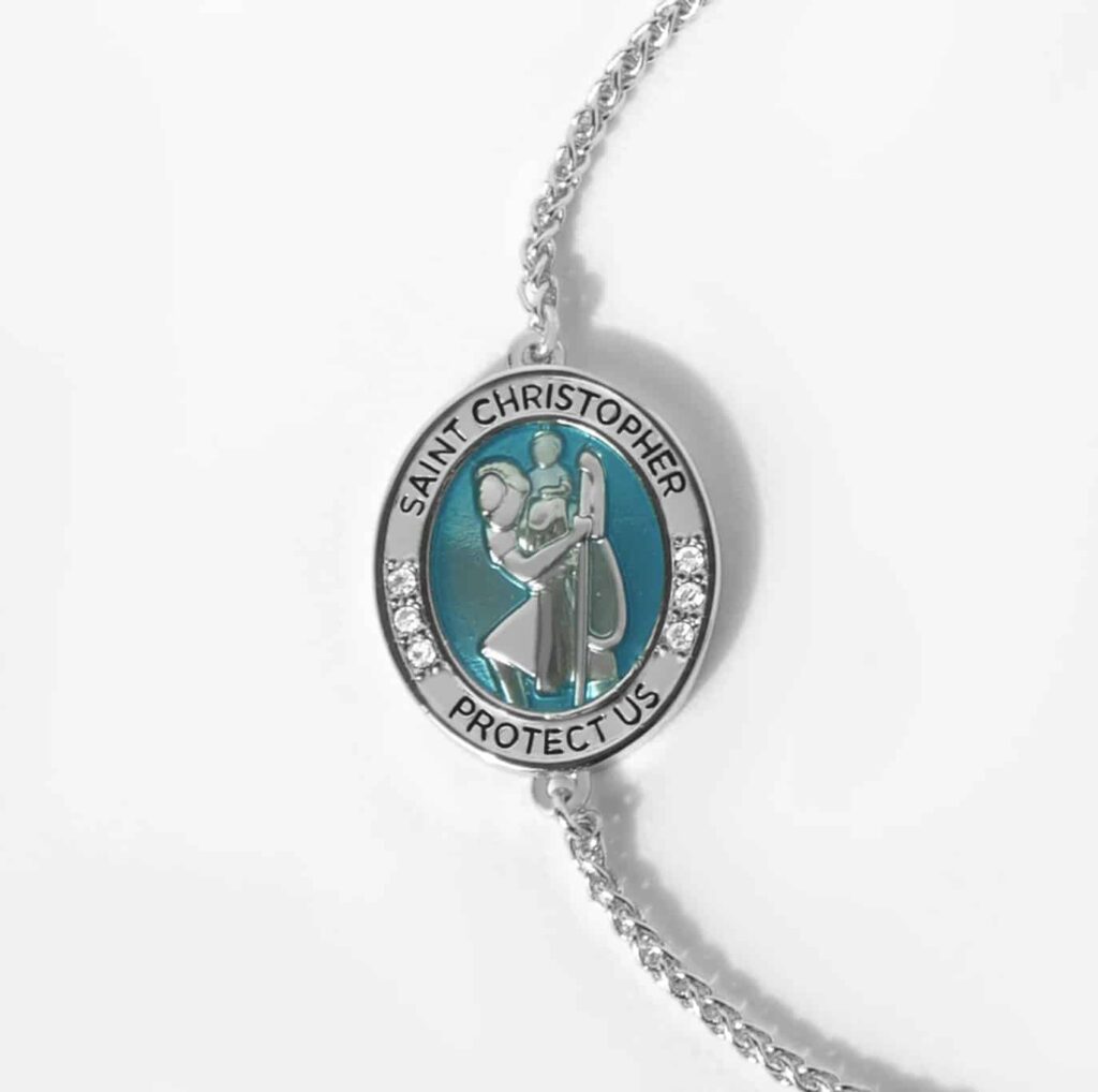 a white background showing one side of the saint christopher medal guide me bolo bracelet in silver