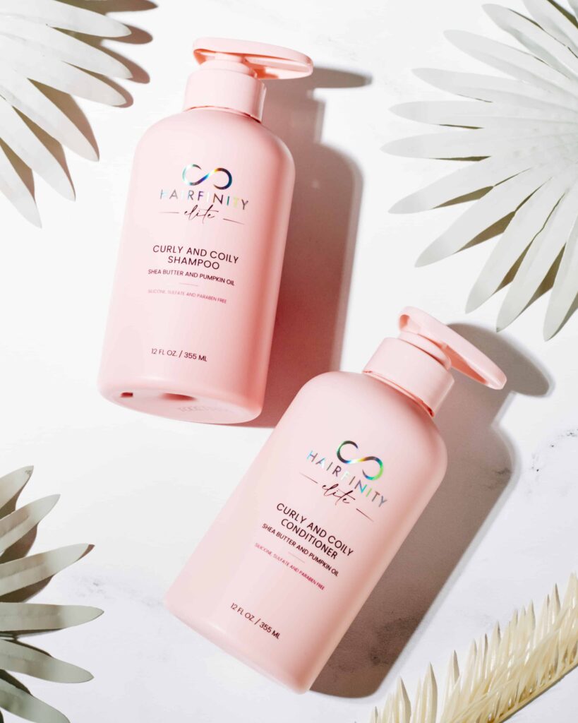 An white image with leaves and the gofinity pink curly and coily shampoo and conditioner which is a way for your shampoo and conditioner customized
