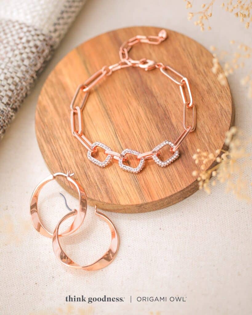 a round wooden plate with the rose gold pave link paperclip bracelet on it and the rose gold twist hoop earrings on the side for fall season 2023
