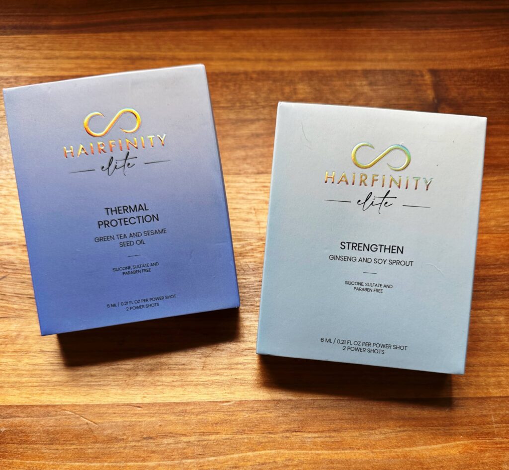 An image showing the Hairfinity Elite outside package of Thermal Protection and Strengthen Power Shots that are in purple and blue boxes