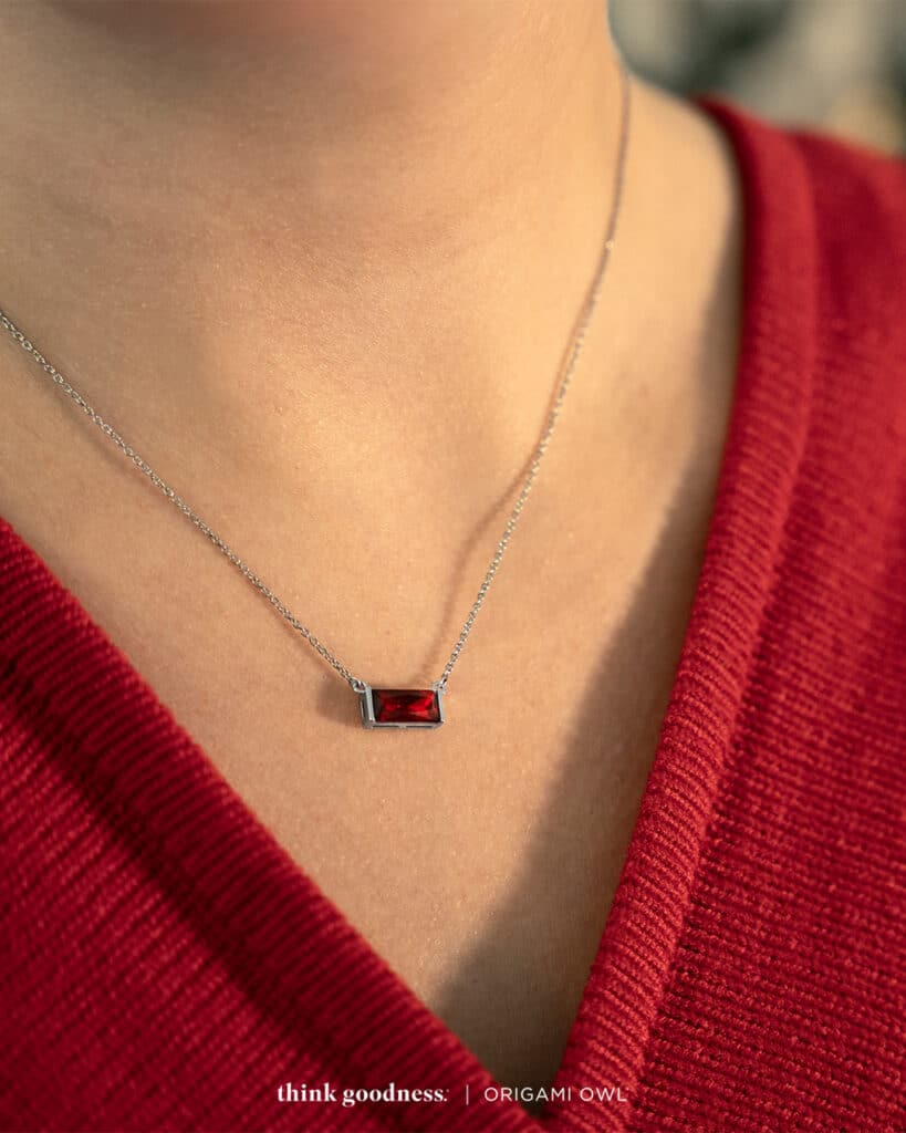an image of a persons neck in a v-neck red sweater wearing Origami Owl Fierce Baguette Pendant necklace