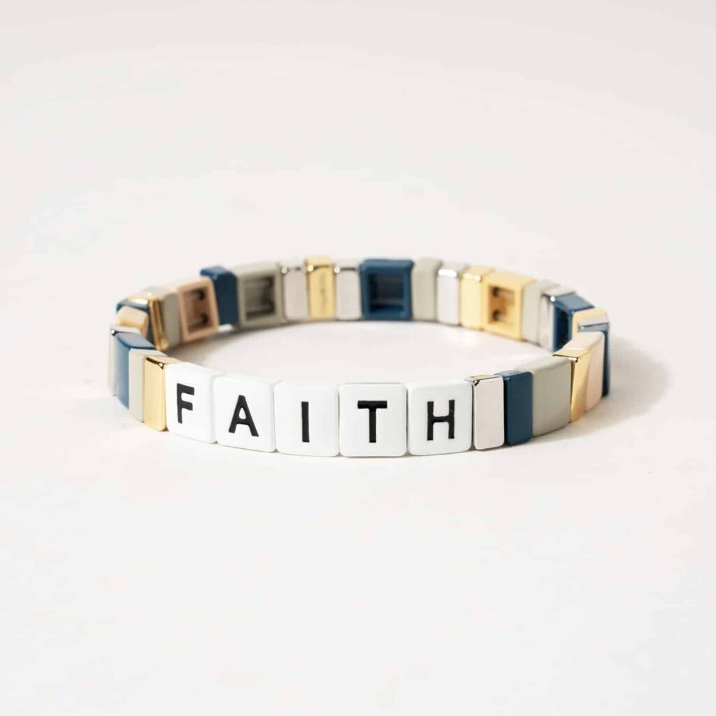 a white background with white tiles that have the words faith on 5 tiles. the other tiles are multi colored and a great way to embrace the spirit of the holiday season