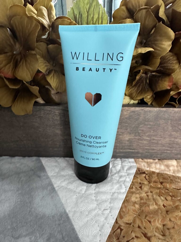 A gold flower background with a tube of Willing Beauty’s Do Over Nourishing Cleanser that is an essential daily Skincare product