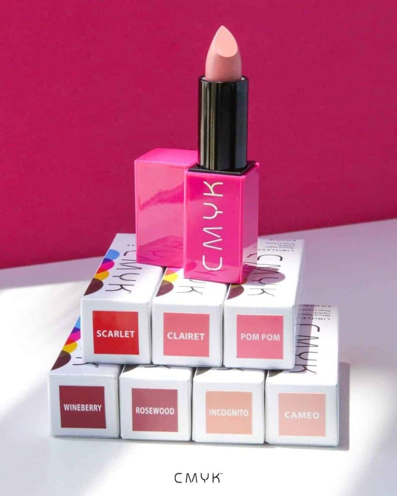 a white and magenta image showing the stacked boxes of the Limitless Natural Vegan Lipsticks with a tube of opened cameo shade standing on top