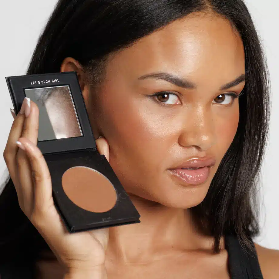 A picture of a woman holding CMYK bronzer 